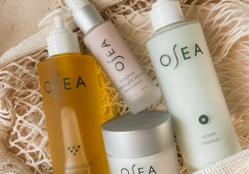 It shows a collection of Osea skincare products, including body oil, serum, cleanser, and protection cream, arranged in a net pouch on a textured surface.