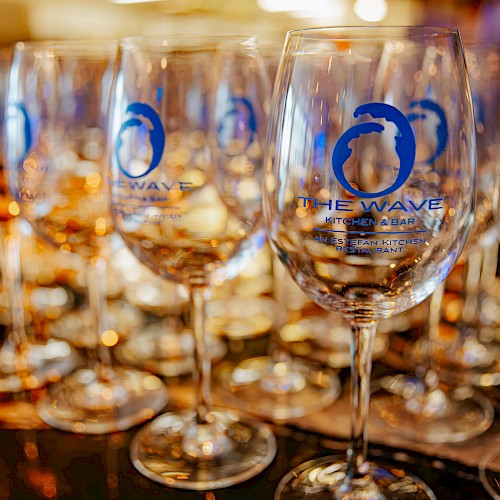 Several wine glasses with the logo 