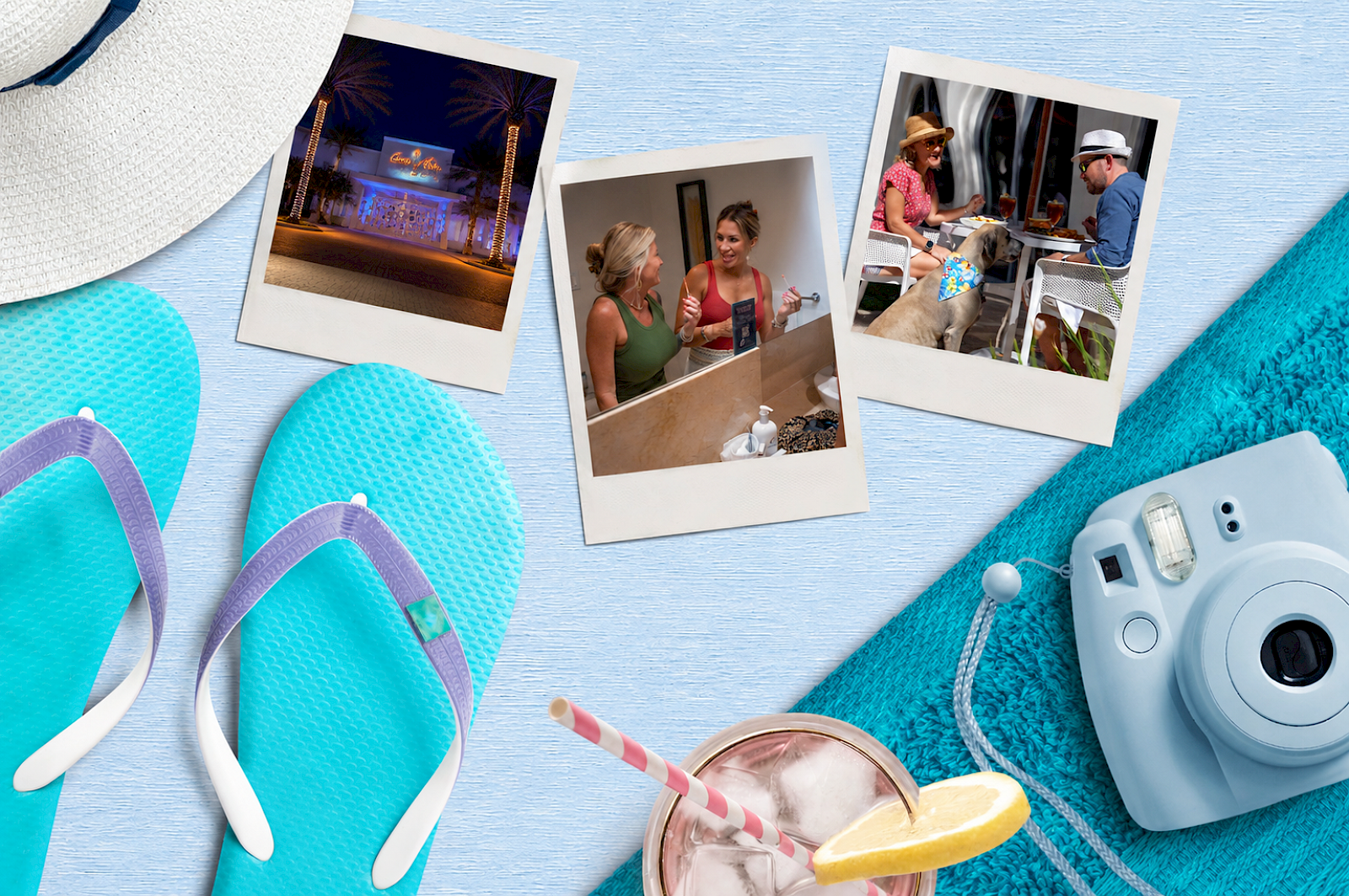 The image shows a flat lay of vacation essentials including flip-flops, a camera, a hat, photos, a drink, and a towel.
