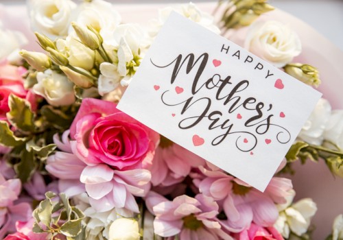 A bouquet of pink and white flowers with a “Happy Mother’s Day” card tucked among them.
