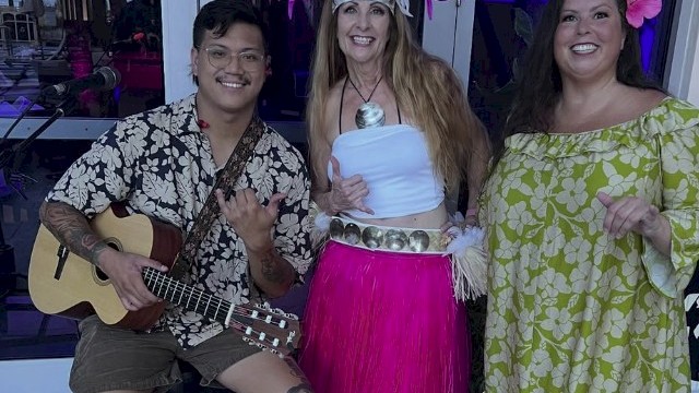 Josiah Nalzaro guitar player with 2 hawaiian dancers